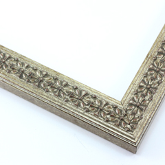 This slim, ornamented design features bevelled inner and outer edges and a celtic cross pattern in relief  The solid wood frame is covered in a gold-brushed silver foil. A faint red patina gives it an antiqued look.

1.25 " width: ideal for smaller artwork.  Photographs, paintings and giclee prints will shine within this detailed frame.